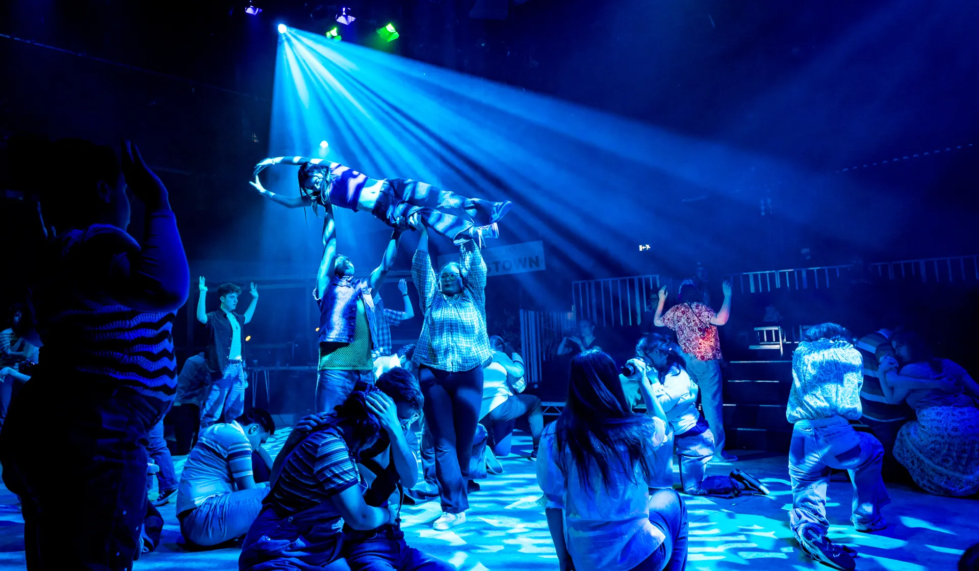 Washing line cast lift eachother in blue wash lighting