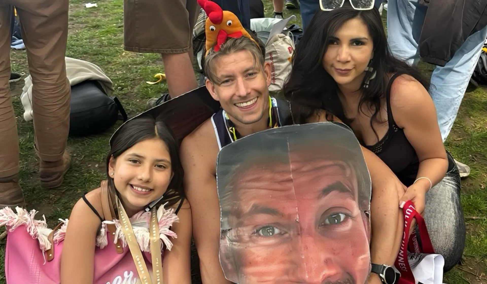 A runner with a big sign of his face at the London marathon