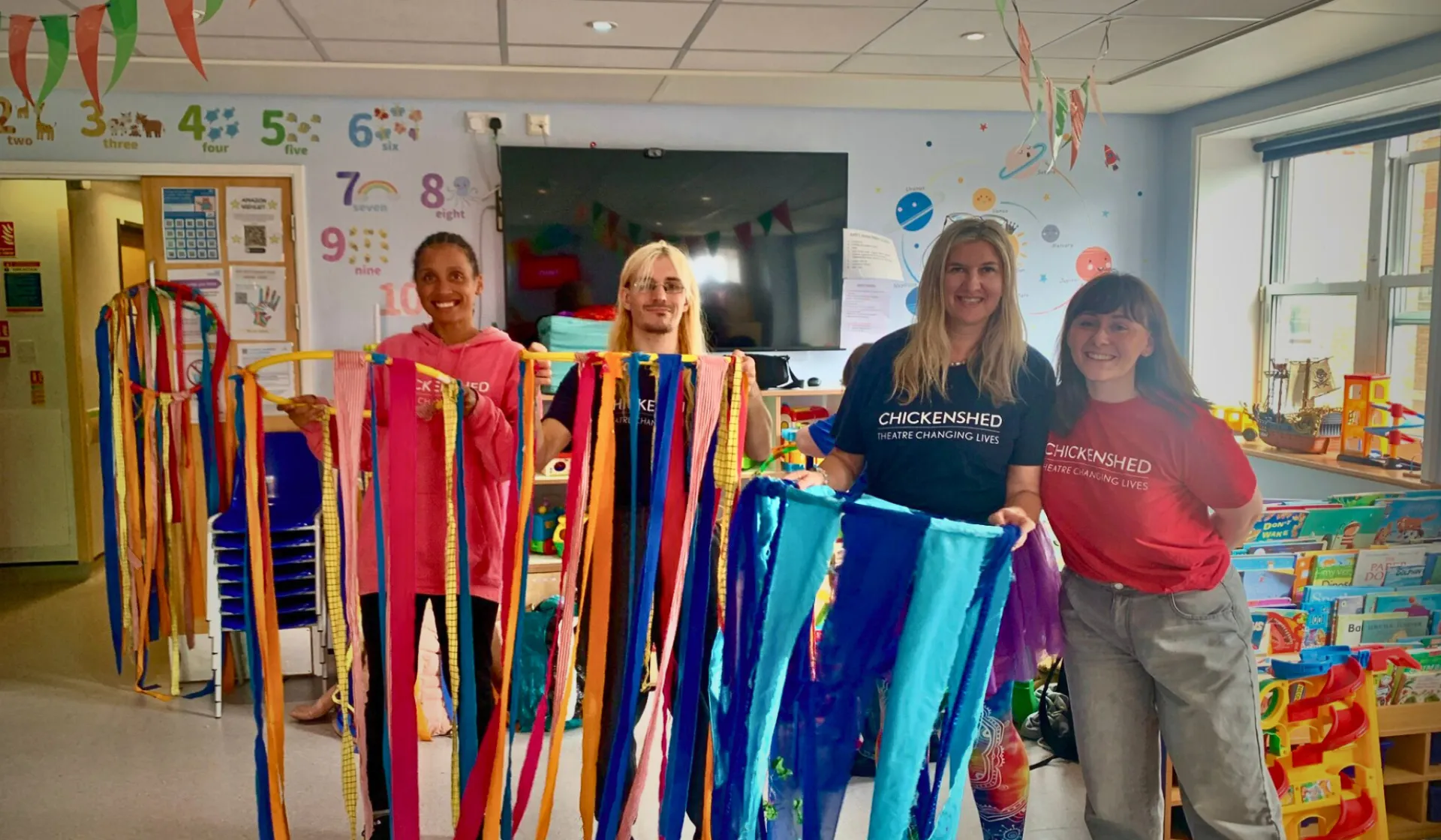 The Taeles team are holidng hoops with drapping fabric