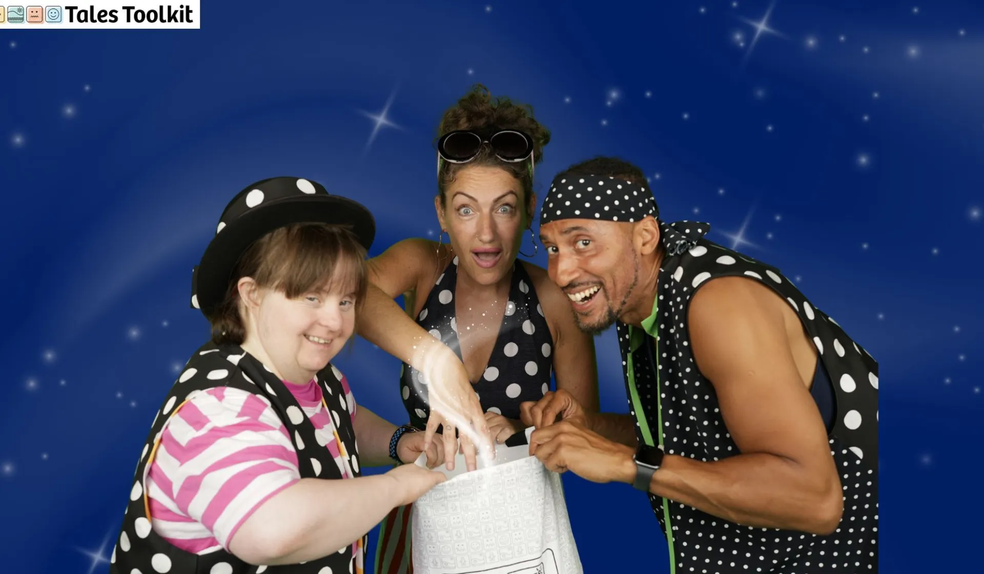Three people looking down at a white bag smiling