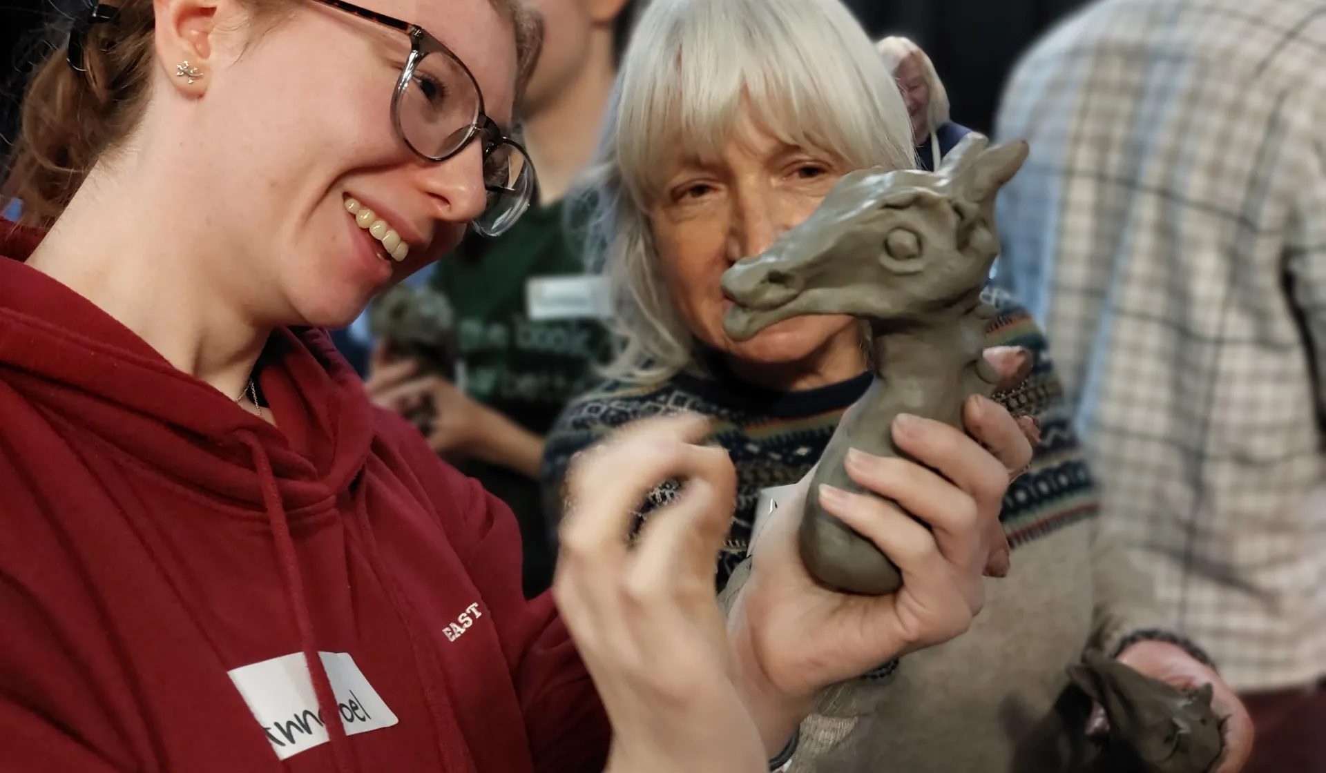 Two people looking at a clay model