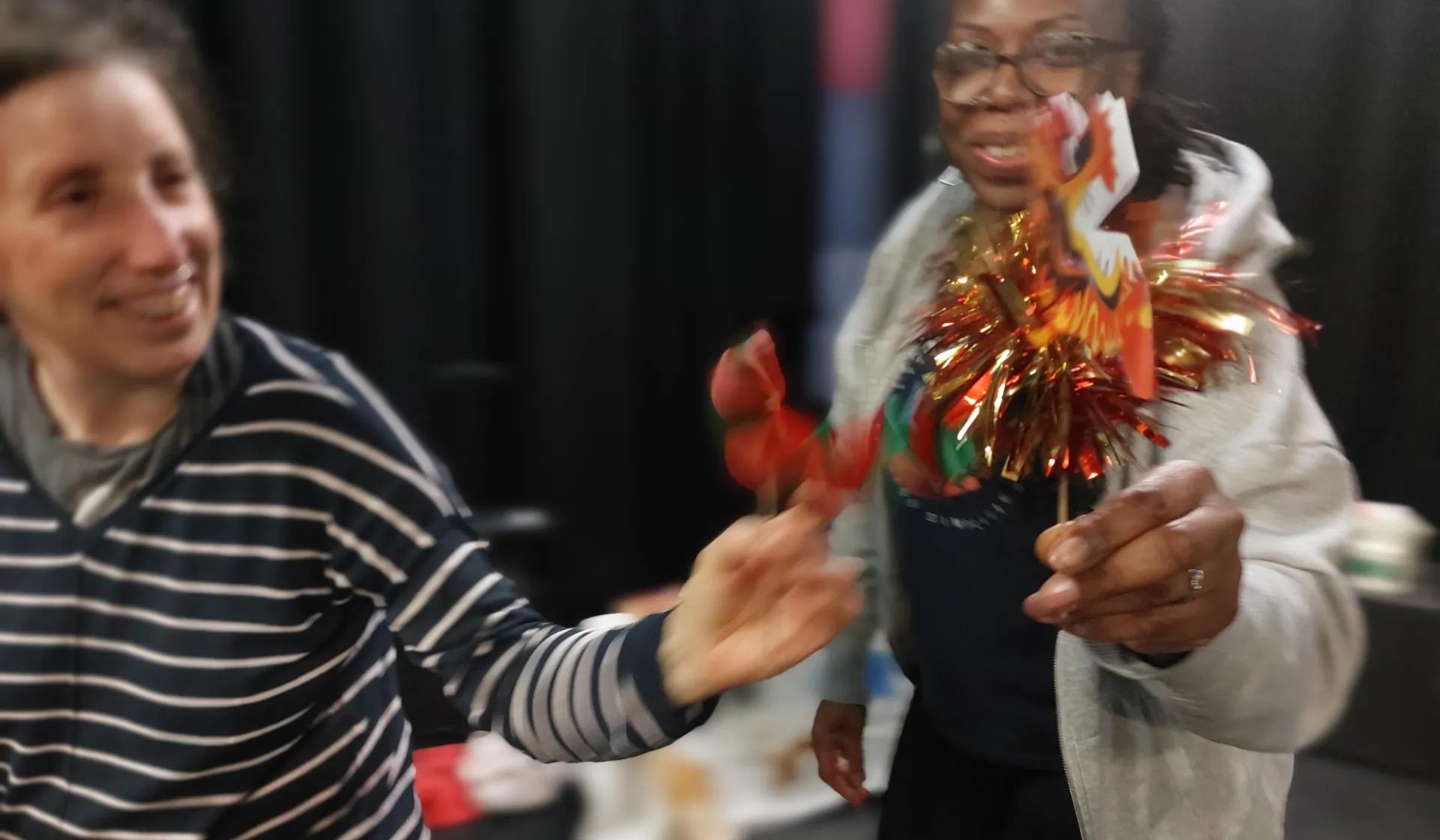 Two women shaking streamers