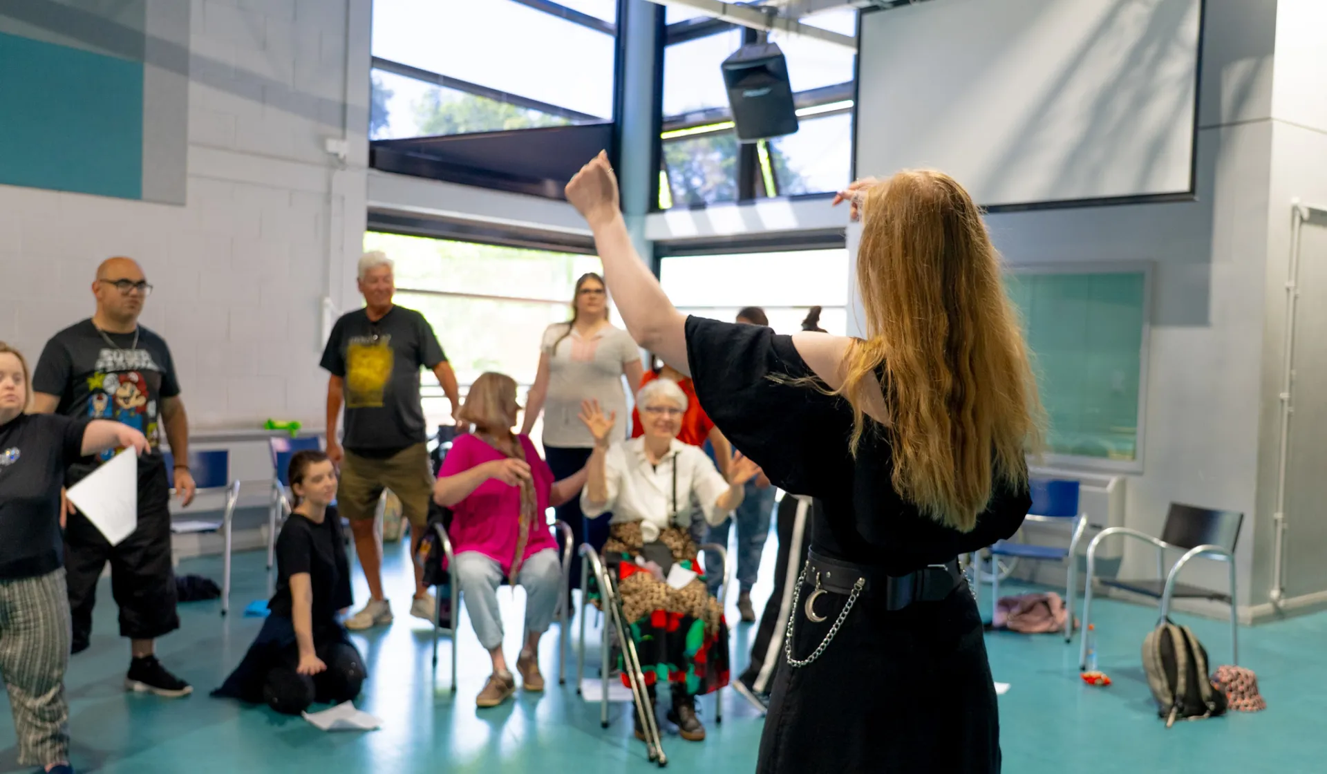 Teacher at front of the room leading a singing lesson