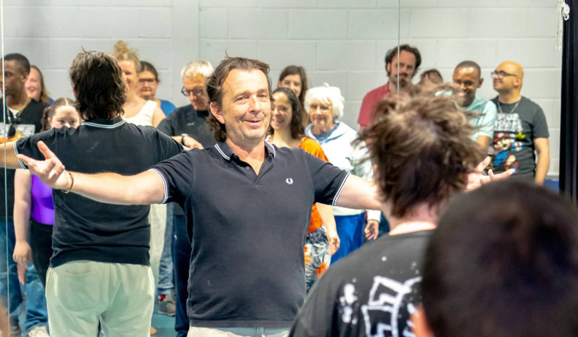 A group of adults acting in a room.