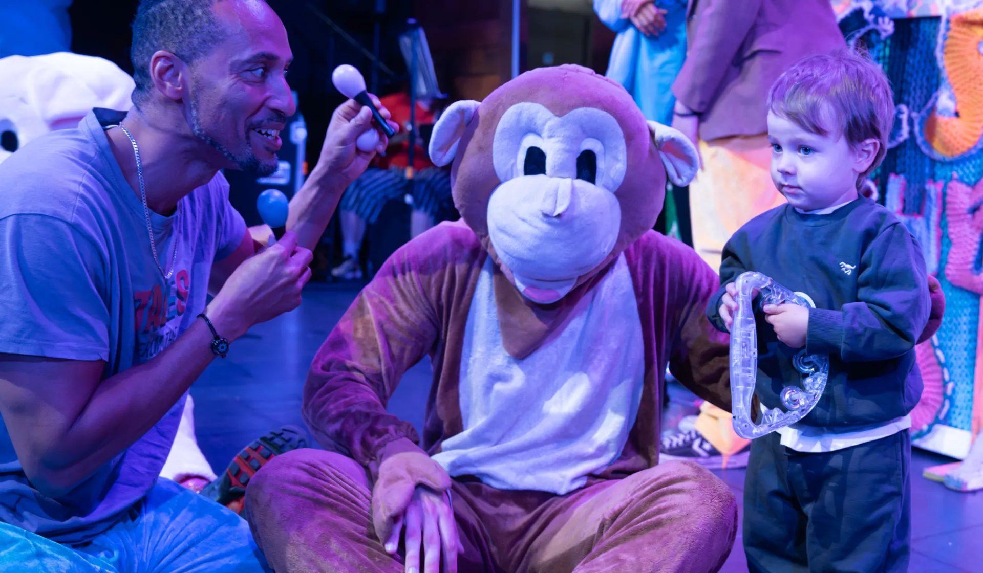 Planet Play - performer interacts with monkey and child