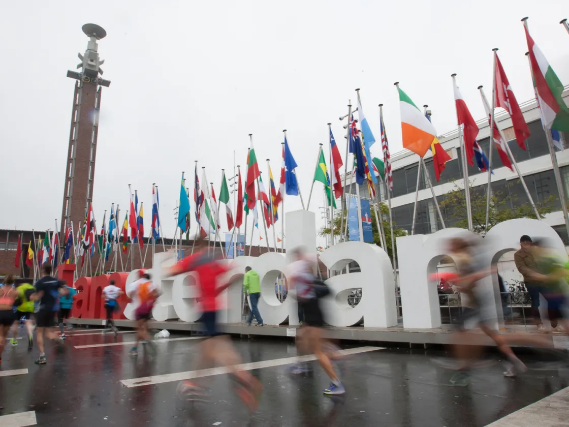 Runers run past and Amsterdam sign