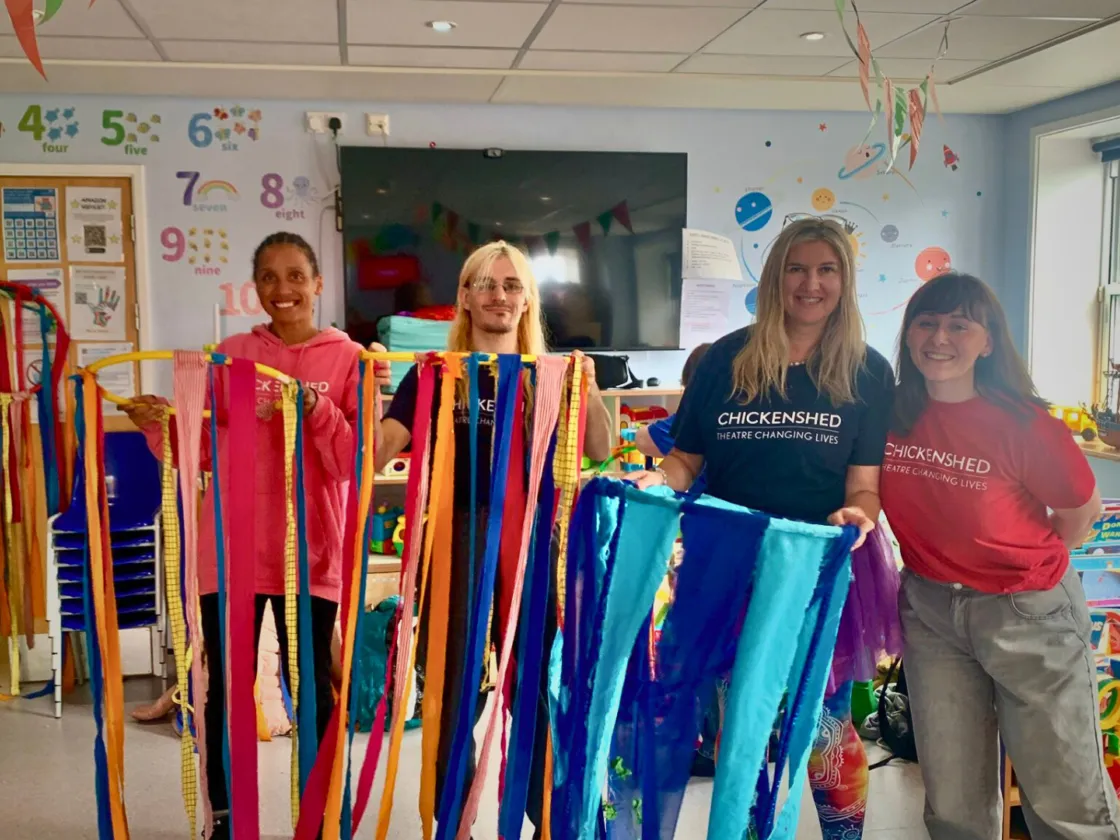 The Taeles team are holidng hoops with drapping fabric