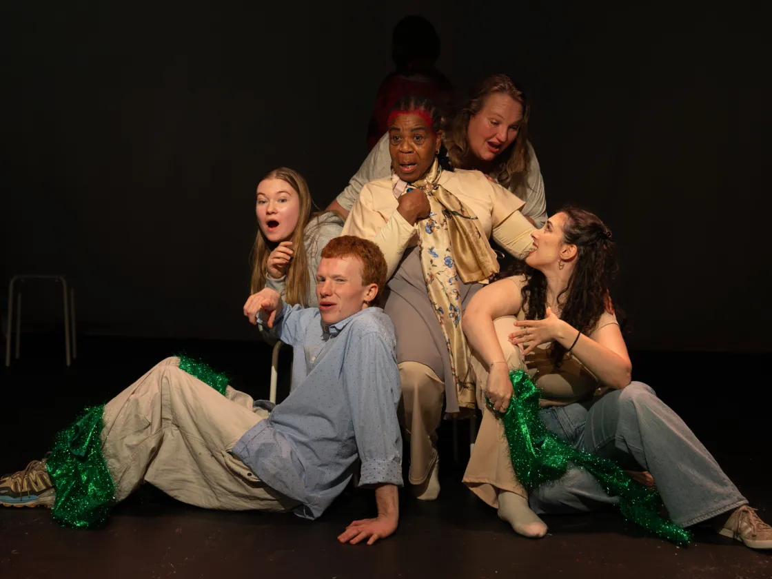 Group of people around a lady in a chair