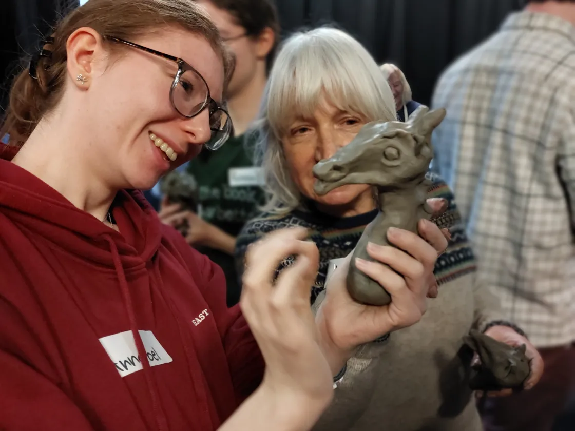 Two people looking at a clay model