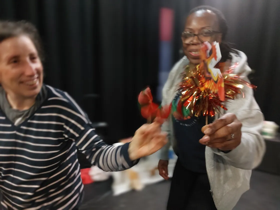 Two women shaking streamers