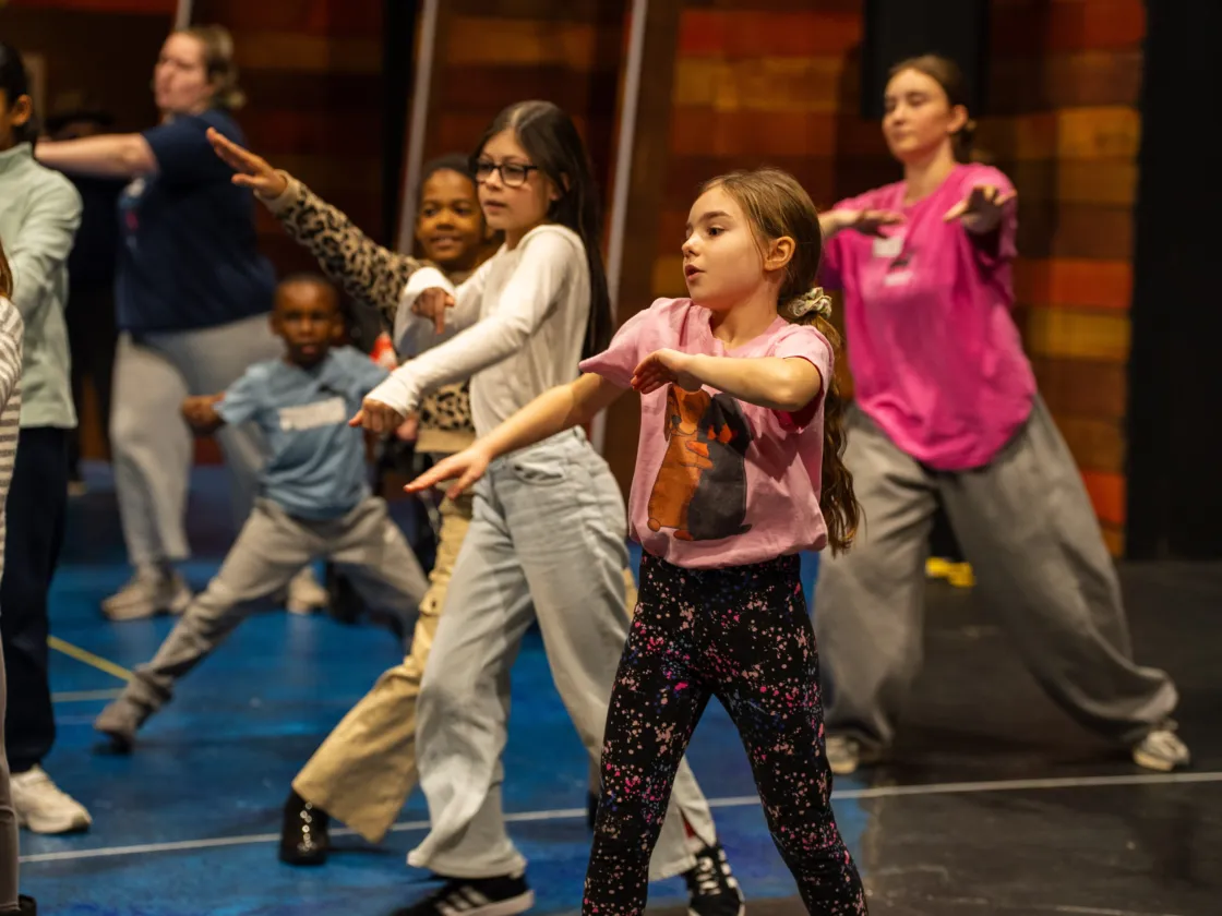 A group of children with their hands stretched out in front of them.