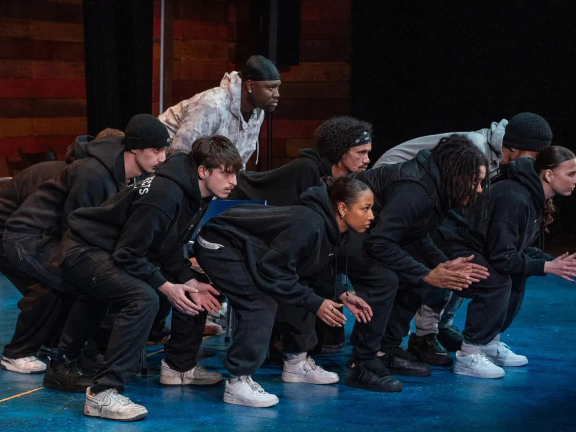 group dancing with their knees bent and arms out