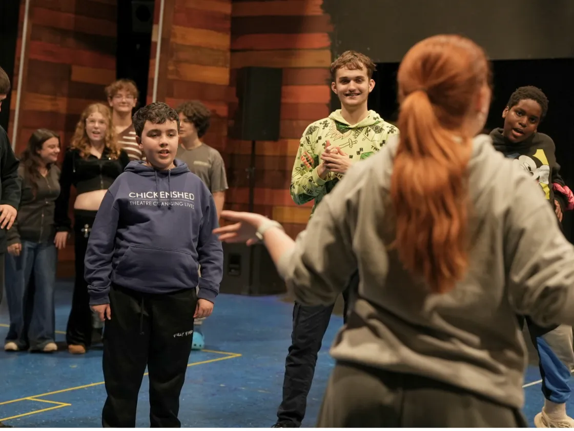 A group of children 11-18 acting on stage