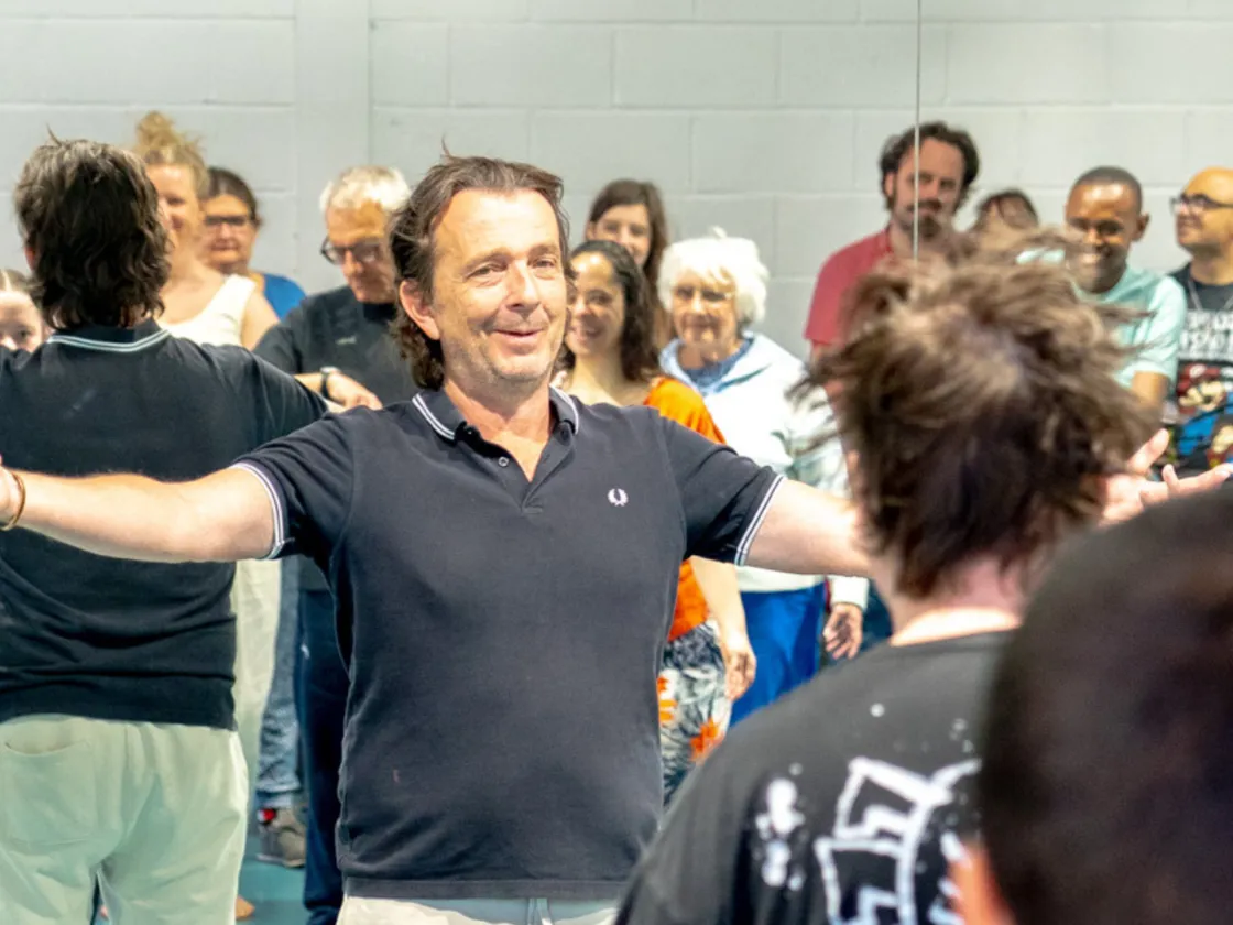 A group of adults acting in a room.