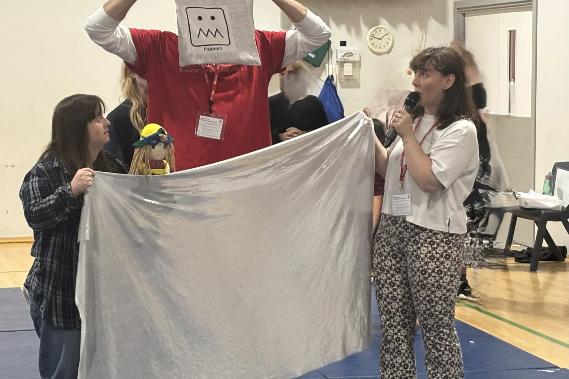 pete stood with a bag in front of his face with puzzled drawing on bag