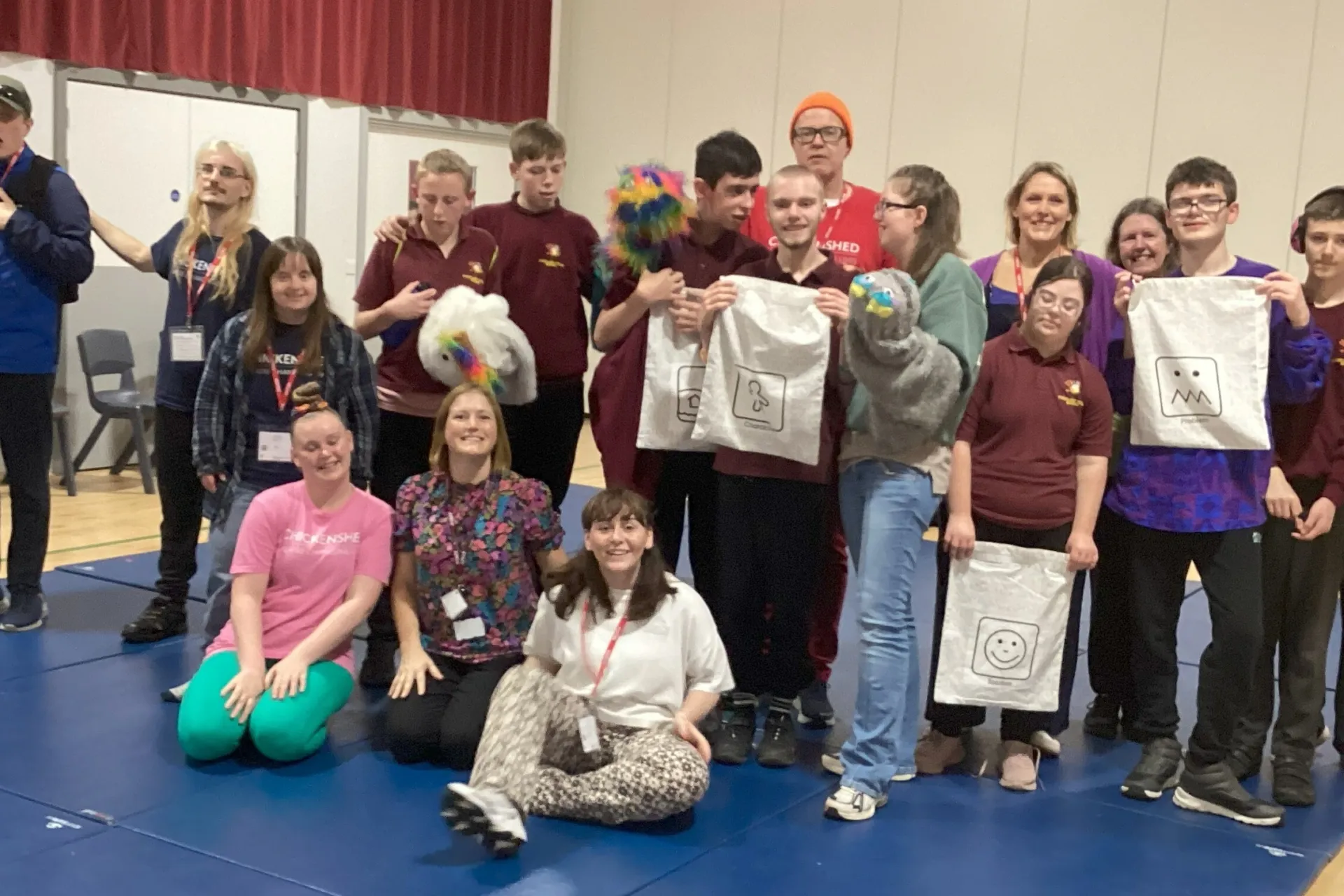 big group in colourful tops smiling