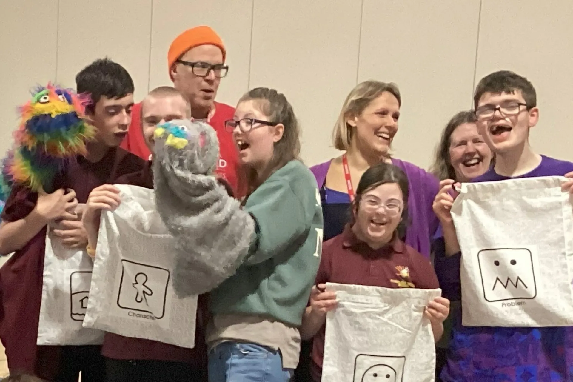 A group stood in a line together for a photo smiling