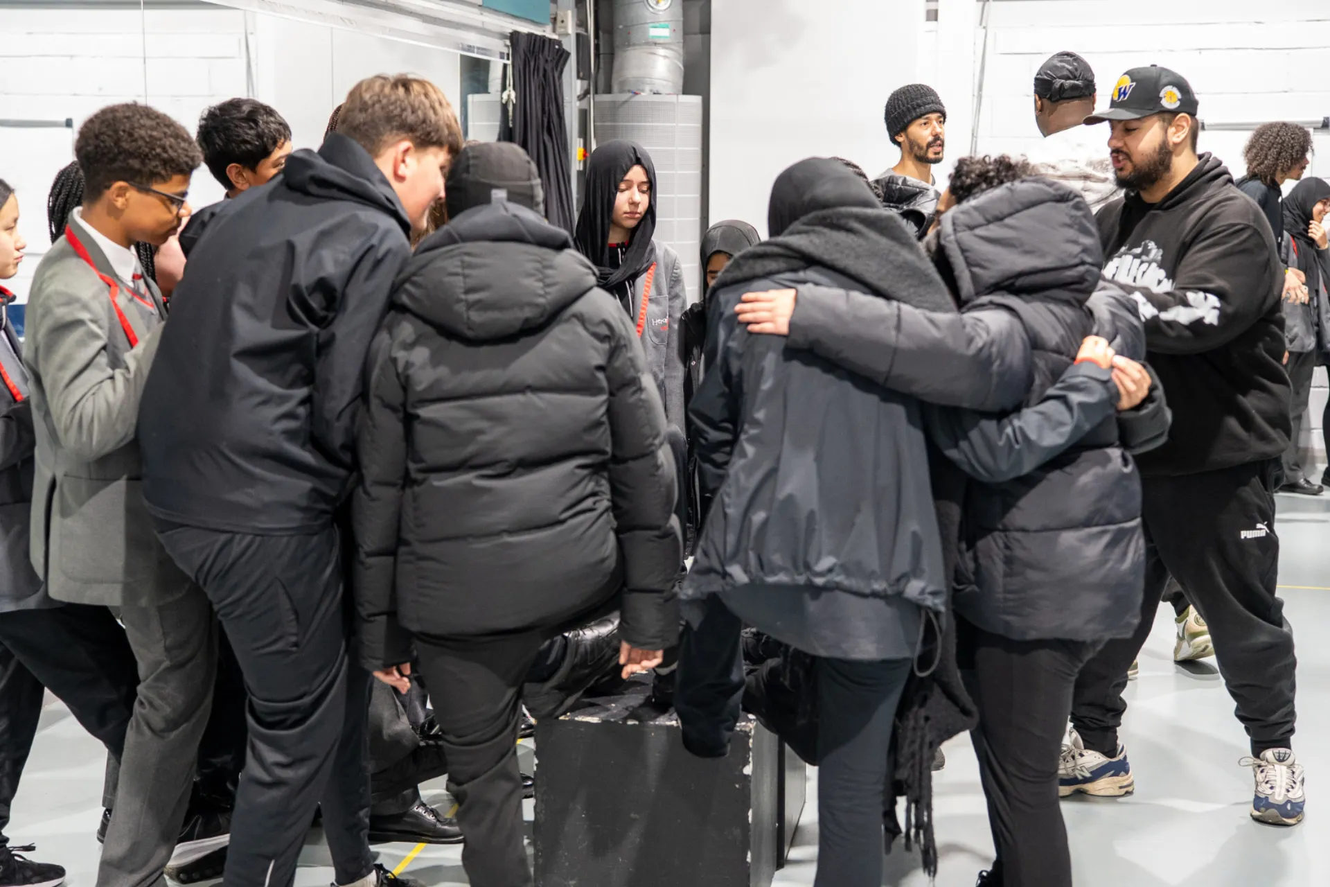 Group of students huddled togethr in workshops