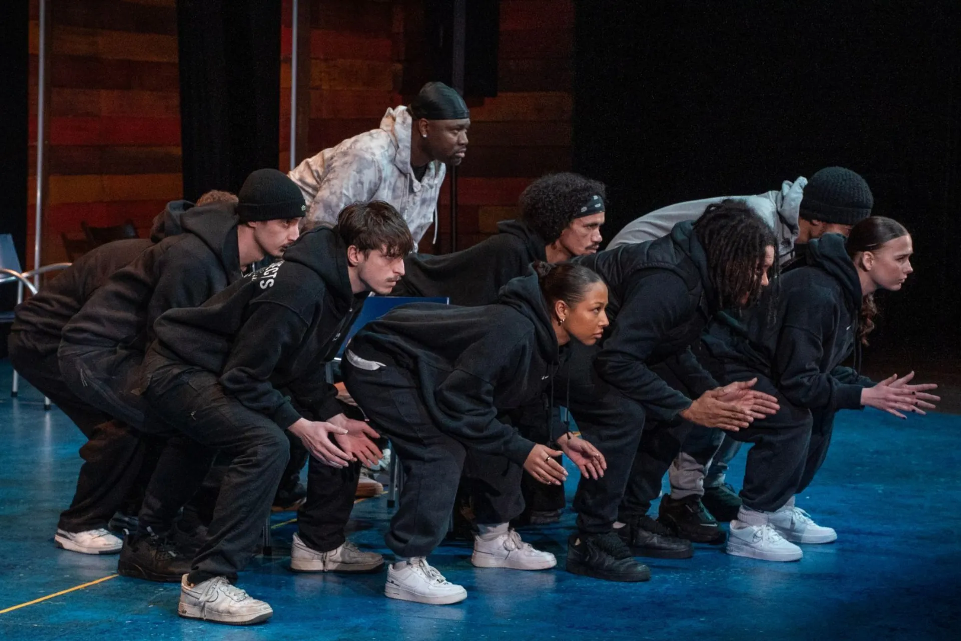 group dancing with their knees bent and arms out